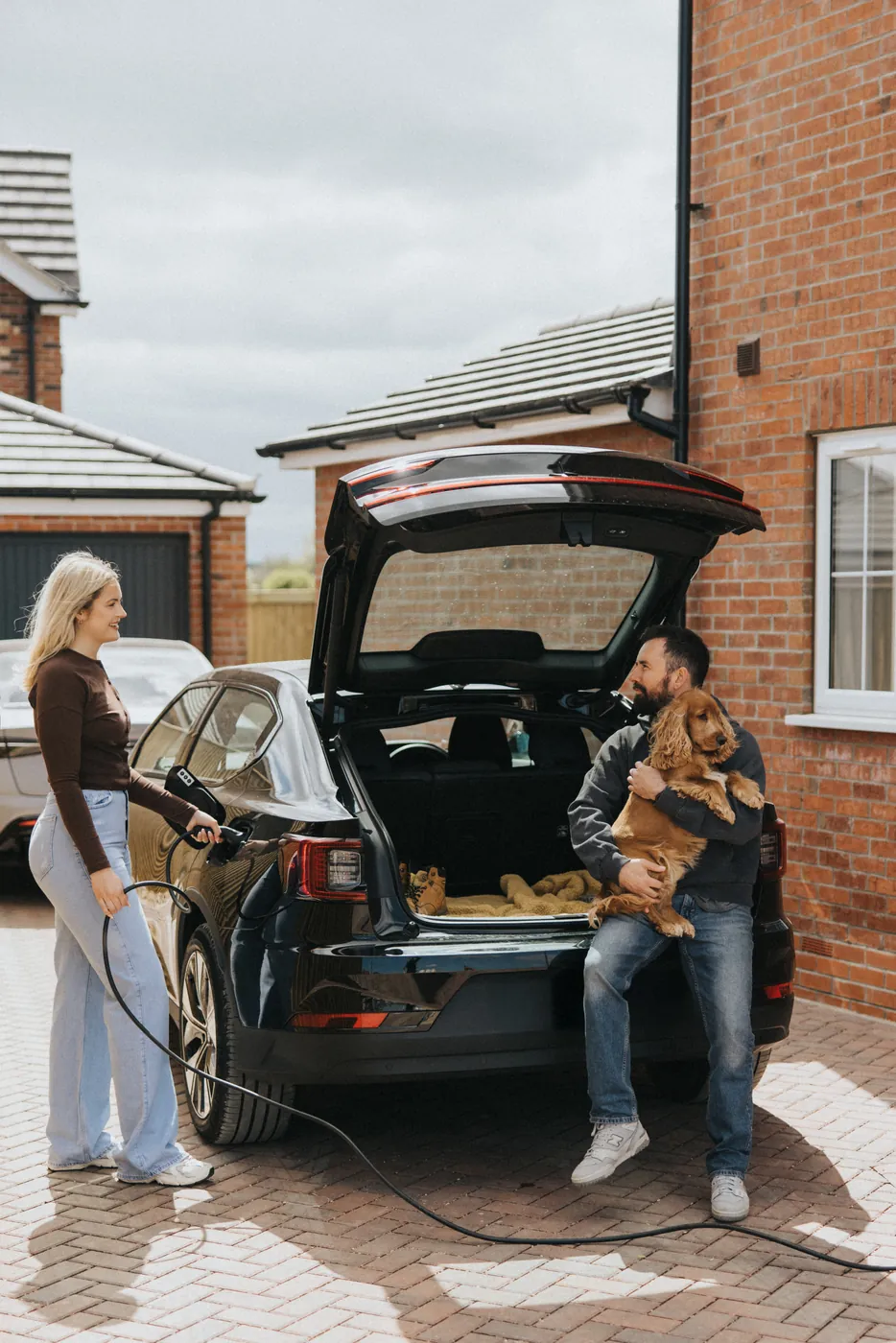 Family charging an electric car with a zappi GLO home charger in Nottingham